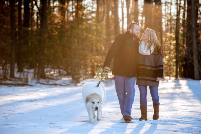 Snow engagement session on a sunny morning with their dog