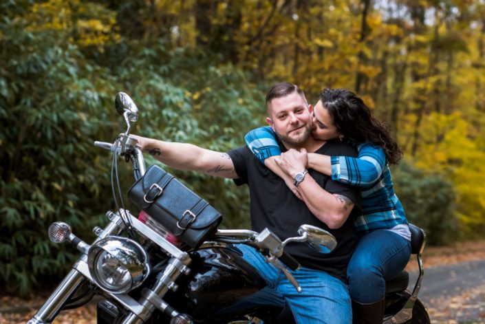 Fun motorcyle photo while the couple snuggles during their engagement session