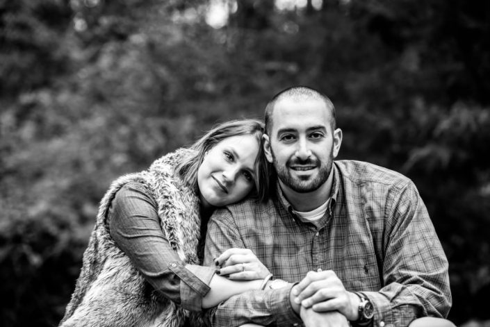 Sweet engaged couple embrace for a black and white photo