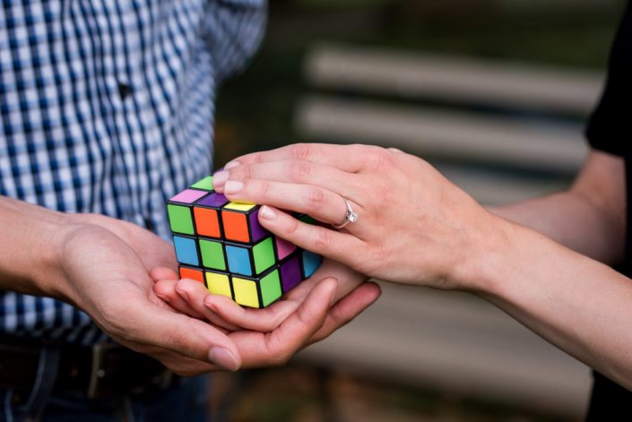 Rubix cube competitors show off the bride's engagement ring in a photo
