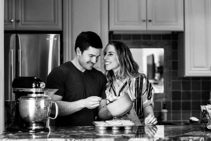 In home photo session in the kitchen for an engagement photo with the couple cooking together