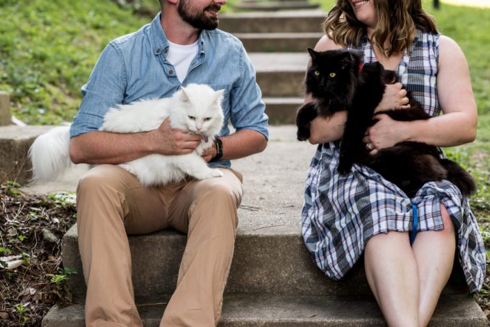 Engaged couple take photos with their cat furbabies outside their home in Richmond, VA