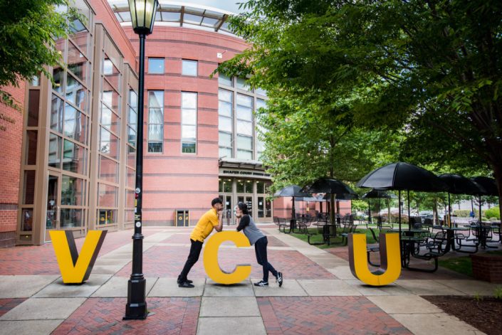 Couple who met on campus at VCU pose for engagement photos at the college campus in Richmond, VA