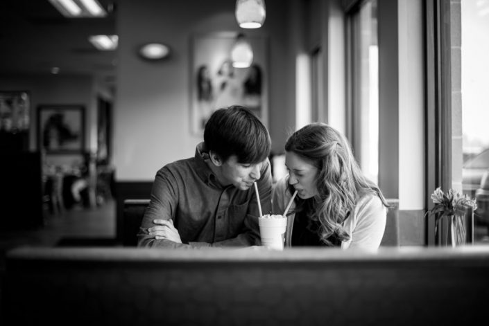 Cute couple share a milkshare for their engagement photo at Chick-Fil-A in Mechanicsville, VA