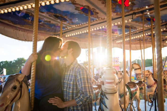 Colorful engagement session on the carousel horses at the State Fair at Meadow Event Pak in Caroline Virginia