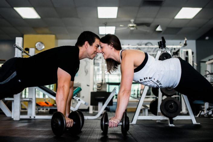 Fun weightlifting couple work out together for their engagement photo in Chesterfield VA