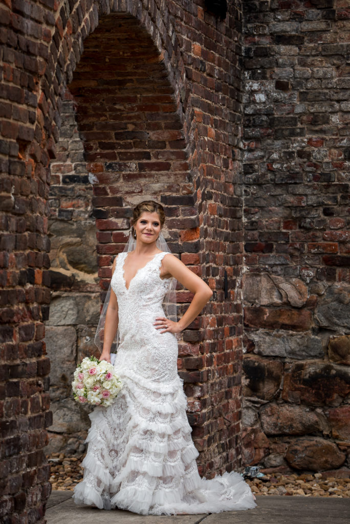 Urban bridal portrait at Historic Tredegar Iron Works in Richmond, VA with stone brick wall