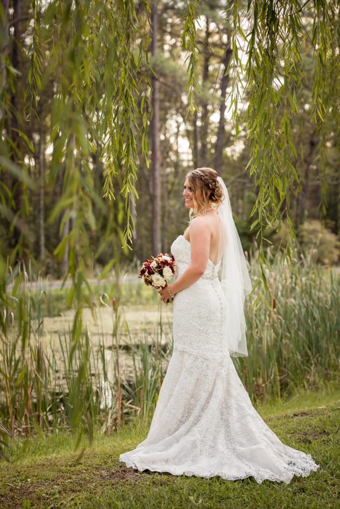 Posed Bridal portrait under weeping willow tree in Tidewater, VA