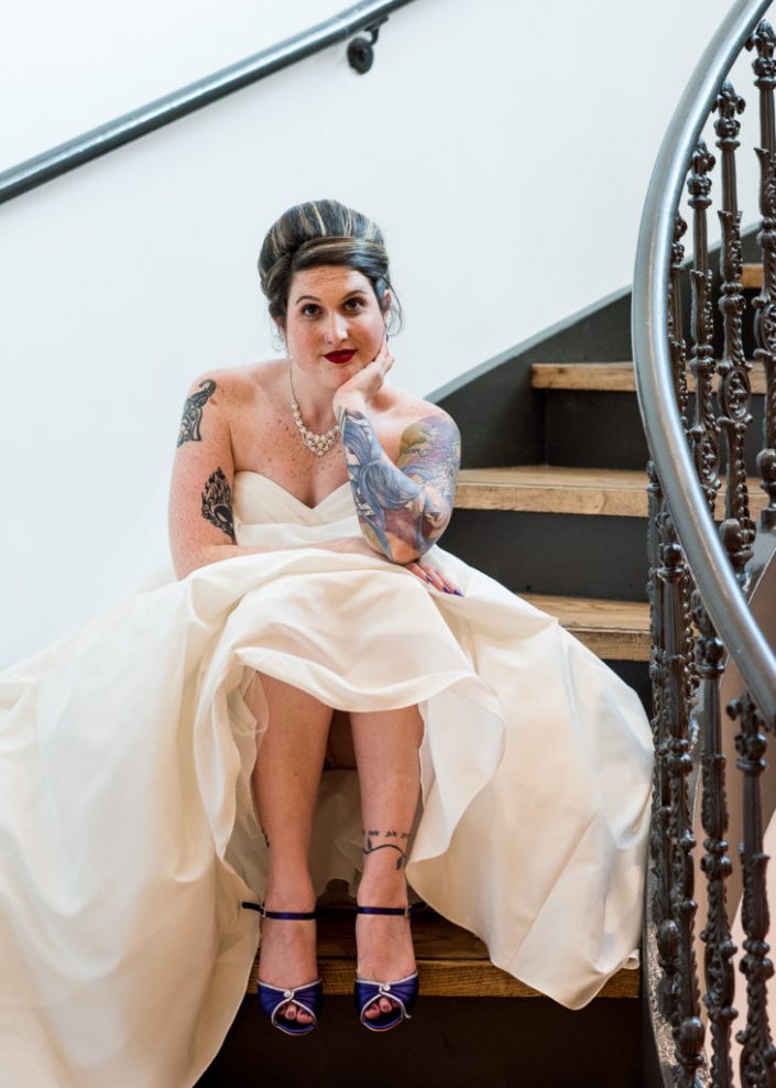 Tattoo bride poses for portrait on staircase of Valentine's Museum in RVA