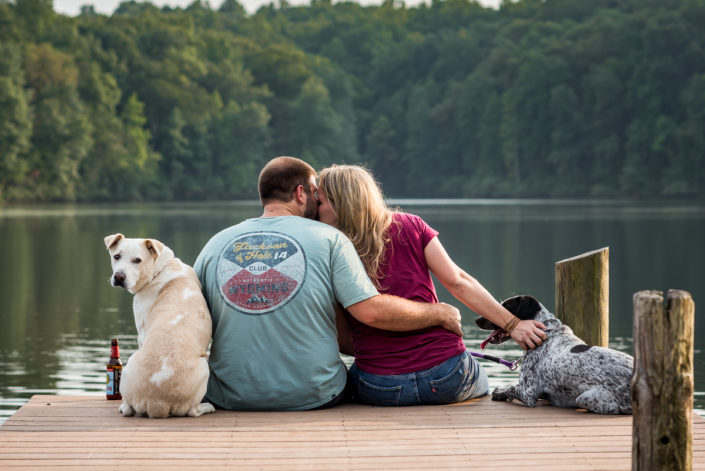 Engagement photo with dogs on the dock in Chris Green Lake Park, Charlottesville, VA