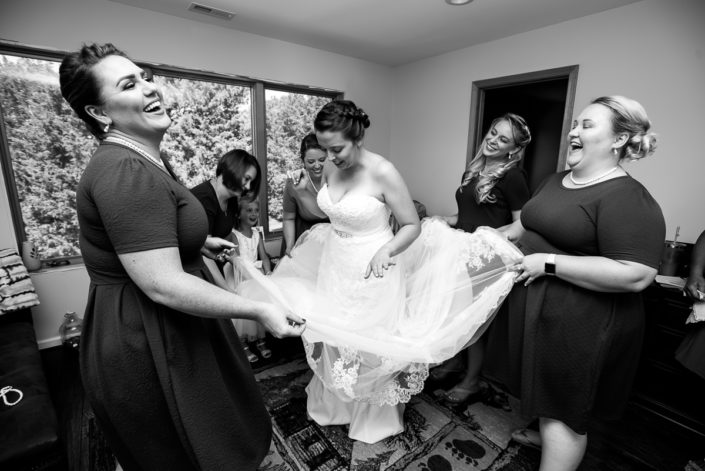 Bridesmaids candid photos while helping bride get dressed Lake Anna Virginia