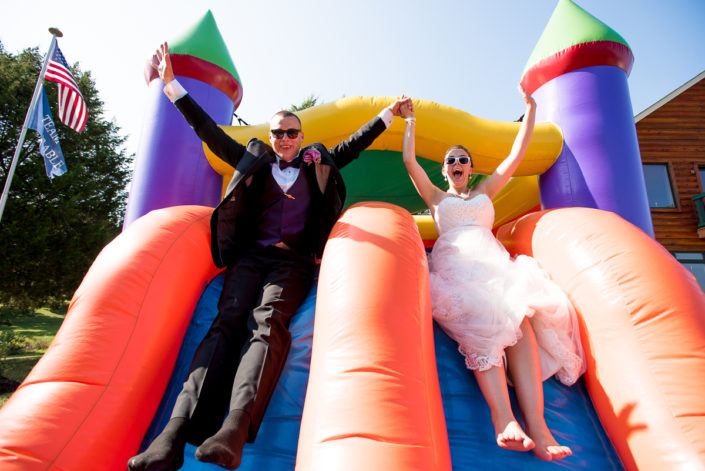 Bride and groom take the plunge in this fun bounce house photo during Lake Anna VA wedding
