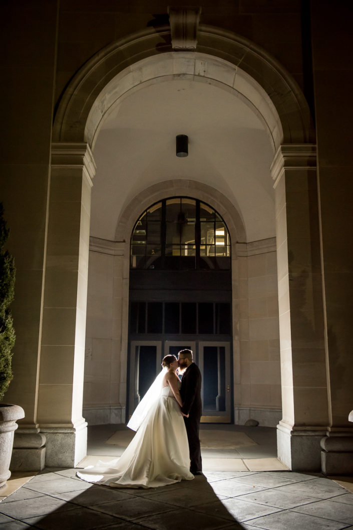 night portrait of bride and groom in the archway of Science Museum Richmond VA