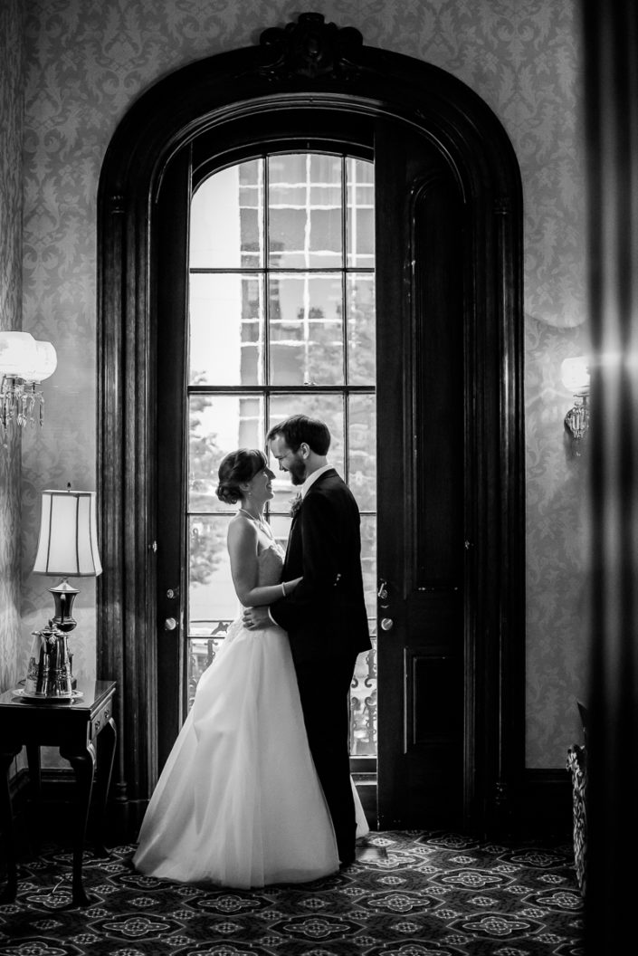 black and white photo of a quiet moment in front of a window at Bolling Haxall House wedding