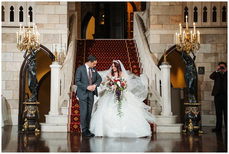 Bride comes down grand staircase at Dover Hall