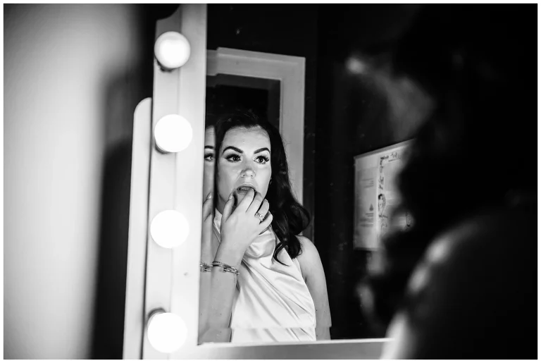 Bride looks in the mirror at Hotel Greene wedding in Richmond VA